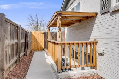 a wooden deck on the side of a house at Cozy Garden Suite by Sloan's Lake and Tennyson! in Wheat Ridge
