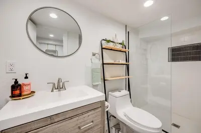 a bathroom with a sink and a toilet and a mirror at Cozy Garden Suite by Sloan's Lake and Tennyson! in Wheat Ridge