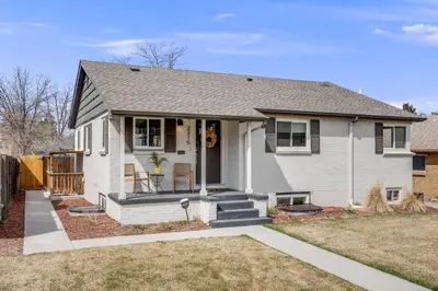 a white house with a porch and a yard at Cozy Garden Suite by Sloan's Lake and Tennyson! in Wheat Ridge