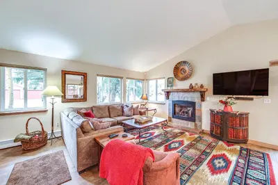 a living room with a couch and a fireplace at Walk to Ski Shuttle Dtwn Frisco Gem with Fireplace! in Frisco