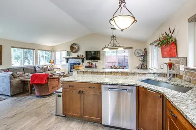 a kitchen with a sink and a living room at Walk to Ski Shuttle Dtwn Frisco Gem with Fireplace! in Frisco