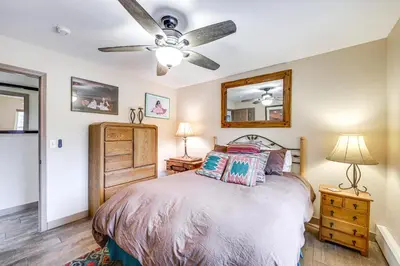 a bedroom with a bed and a ceiling fan at Walk to Ski Shuttle Dtwn Frisco Gem with Fireplace! in Frisco