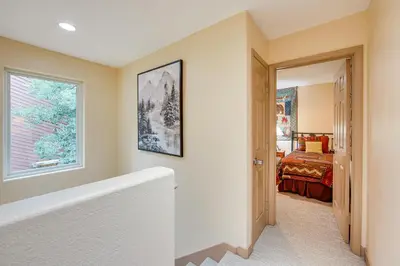 a bathroom with a bath tub and a bedroom at Walk to Ski Shuttle Dtwn Frisco Gem with Fireplace! in Frisco