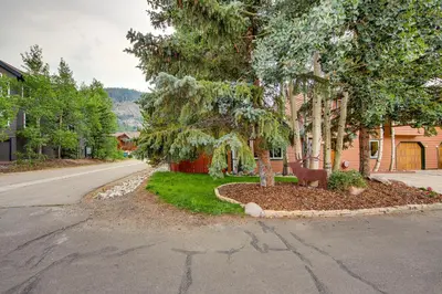 a street with trees and a road with a house at Walk to Ski Shuttle Dtwn Frisco Gem with Fireplace! in Frisco