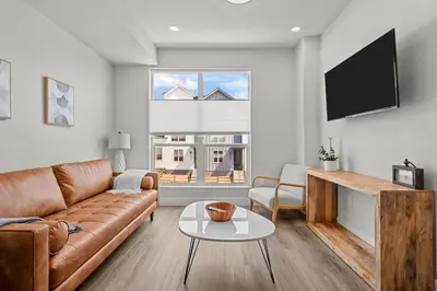 a living room with a couch and a tv at 3534 W 63rd Ave in Denver