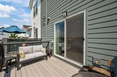 a balcony with a couch and a glass door at 3534 W 63rd Ave in Denver