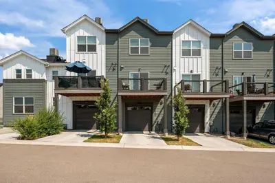 a large apartment building with a car parked in front at 3534 W 63rd Ave in Denver