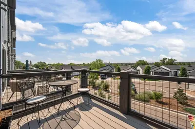 a balcony with a table and a view of a field at 3534 W 63rd Ave in Denver