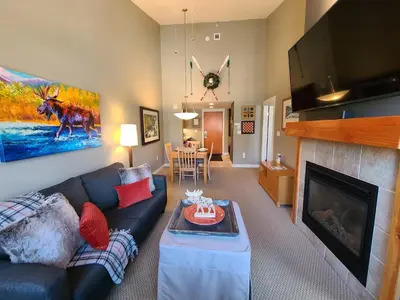 a living room with a couch and a fireplace at Platinum Top Floor Ski-in Ski-out WP Resort in Winter Park