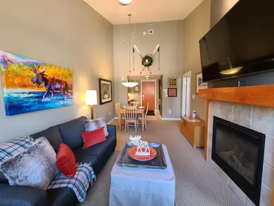 a living room with a couch and a fireplace at Platinum Top Floor Ski-in Ski-out WP Resort in Winter Park