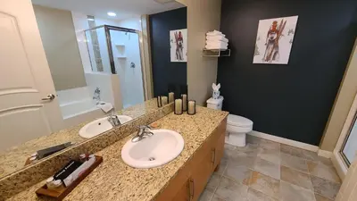 a bathroom with a sink and a mirror and a toilet at Platinum Top Floor Ski-in Ski-out WP Resort in Winter Park