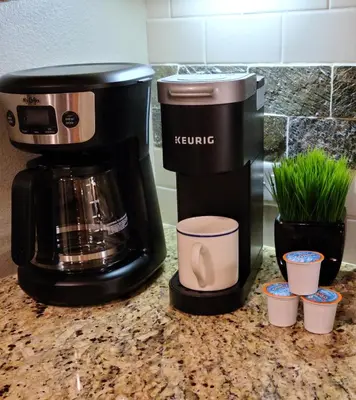 a coffee maker sitting on a counter next to cups at Platinum Top Floor Ski-in Ski-out WP Resort in Winter Park