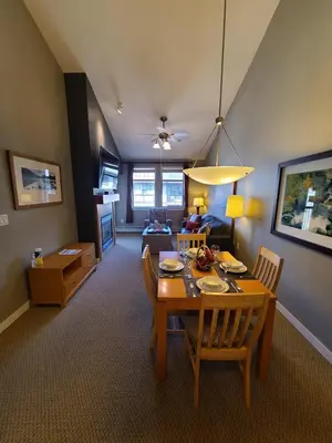 a dining room and living room with a table and chairs at Platinum Top Floor Ski-in Ski-out WP Resort in Winter Park