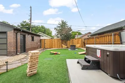 a small backyard with a sandbox and a play set at 5280 Oasis - Hot Tub Walk to Sloan's Lake in Denver