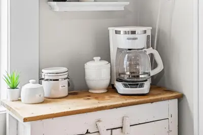 a coffee maker sitting on top of a wooden counter at 5280 Oasis - Hot Tub Walk to Sloan's Lake in Denver