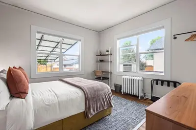 a bedroom with a bed and two windows at 5280 Oasis - Hot Tub Walk to Sloan's Lake in Denver