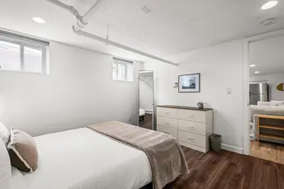 a white bedroom with a bed and a dresser at 5280 Oasis - Hot Tub Walk to Sloan's Lake in Denver