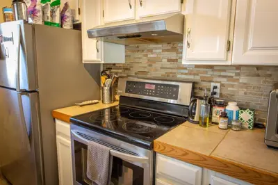 a kitchen with a stove and a refrigerator at Dog Friendly Oasis Private Hot Tub with Sauna in Boulder