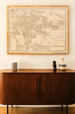 a large map hanging on a wall above a wooden cabinet at Colorful Sunnyside Escape - Walk to Dining & Parks in Denver
