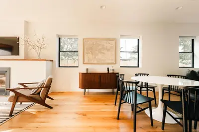 a living room with a table and chairs at Colorful Sunnyside Escape - Walk to Dining & Parks in Denver