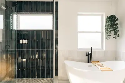 a bathroom with a bath tub and a sink at Colorful Sunnyside Escape - Walk to Dining & Parks in Denver