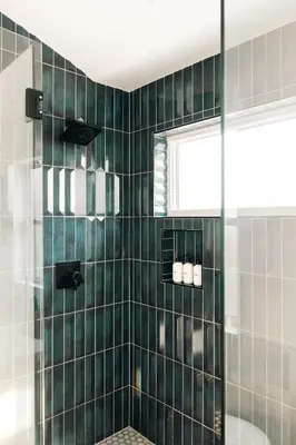 a bathroom with a shower with green tiles at Colorful Sunnyside Escape - Walk to Dining & Parks in Denver