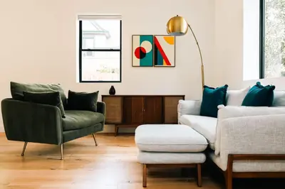 a living room with two chairs and a couch at Colorful Sunnyside Escape - Walk to Dining & Parks in Denver