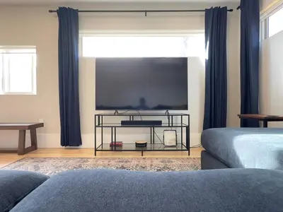 a living room with a large flat screen tv at NEW REMODEL Denver Luxury Home with Private HOT TUB in Denver