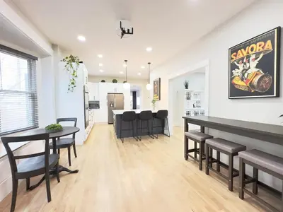 a dining room and living room with a table and chairs at NEW REMODEL Denver Luxury Home with Private HOT TUB in Denver