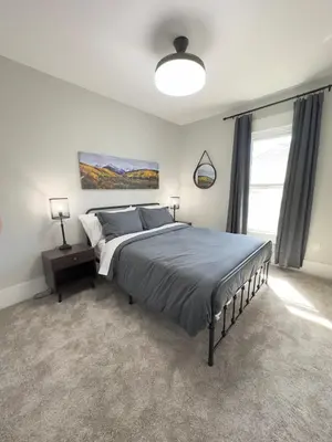 a bedroom with a large bed and a window at NEW REMODEL Denver Luxury Home with Private HOT TUB in Denver