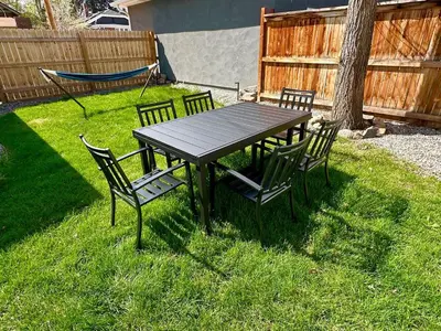a picnic table with four chairs in the grass at NEW REMODEL Denver Luxury Home with Private HOT TUB in Denver