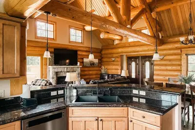 a kitchen with wooden walls and a wooden ceiling at Ski Hike Relax - Log Cabin with Views - Hot tub in Silverthorne