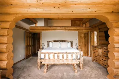 a bedroom with a bed and a wooden ceiling at Ski Hike Relax - Log Cabin with Views - Hot tub in Silverthorne