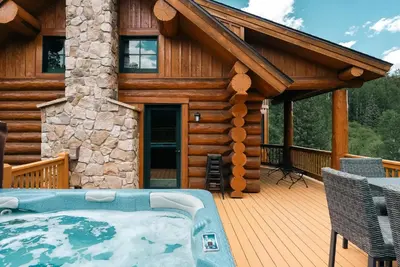 a log cabin with a hot tub on a deck at Ski Hike Relax - Log Cabin with Views - Hot tub in Silverthorne