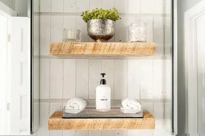 a bathroom shelf with a bottle of soap and towels at Ski Hike Relax - Log Cabin with Views - Hot tub in Silverthorne