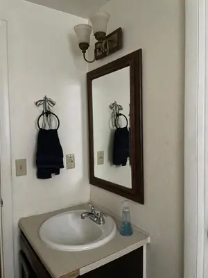 a bathroom with a sink and a mirror at Sunny and Spacious, Hottub, Piano, Guitars, Fenced Yard, Pets Welcome, LGBT Friendly in Westminster