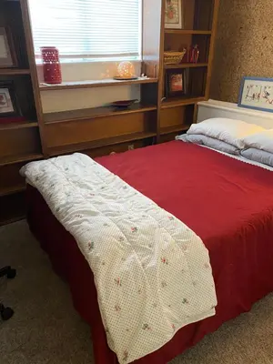 a bedroom with a bed with a red blanket at Sunny and Spacious, Hottub, Piano, Guitars, Fenced Yard, Pets Welcome, LGBT Friendly in Westminster
