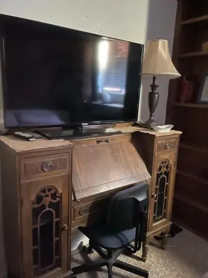 a desk with a television and a chair with a lamp at Sunny and Spacious, Hottub, Piano, Guitars, Fenced Yard, Pets Welcome, LGBT Friendly in Westminster