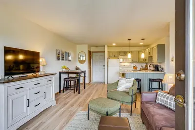 a kitchen and living room with a couch and a table at Ski and Adventure Base Mtn-View Silverthorne Condo in Silverthorne
