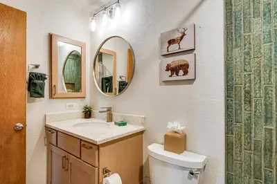 a bathroom with a sink and a toilet and a mirror at Ski and Adventure Base Mtn-View Silverthorne Condo in Silverthorne