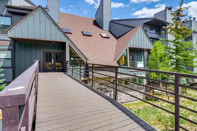 a wooden walkway leading to a house at Ski and Adventure Base Mtn-View Silverthorne Condo in Silverthorne