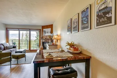 a living room with a wooden table and a living room at Ski and Adventure Base Mtn-View Silverthorne Condo in Silverthorne