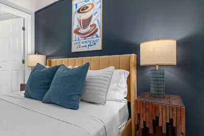 a bedroom with a bed with a blue wall at 6BR Family Retreat with Games Billiards Mini Golf BBQ and Yard in Westminster