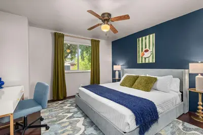 a bedroom with a bed and a ceiling fan at 6BR Family Retreat with Games Billiards Mini Golf BBQ and Yard in Westminster