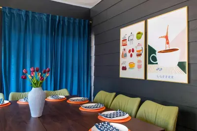 a dining room with a table and a vase of flowers at 6BR Family Retreat with Games Billiards Mini Golf BBQ and Yard in Westminster