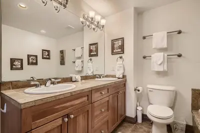 a bathroom with a sink and a toilet and a mirror at Highland Greens 42 in Breckenridge