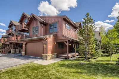 a large wooden house with a garage at Highland Greens 42 in Breckenridge