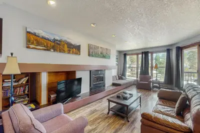 a living room with a couch and a tv at Quicksilver 1654 in Keystone