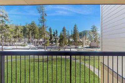 a balcony with a view of a field of grass at Quicksilver 1654 in Keystone