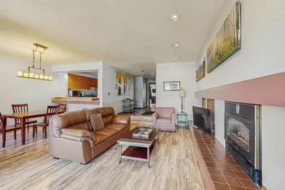 a living room with a couch and a fireplace at Quicksilver 1654 in Keystone